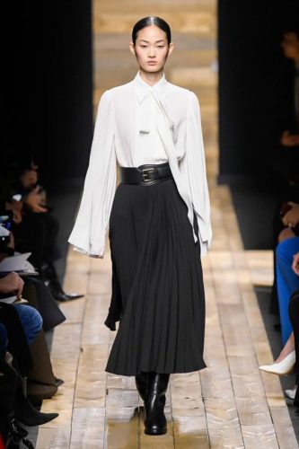 White bouse and black pleated skirt Michael Kors Collection Fall 2020